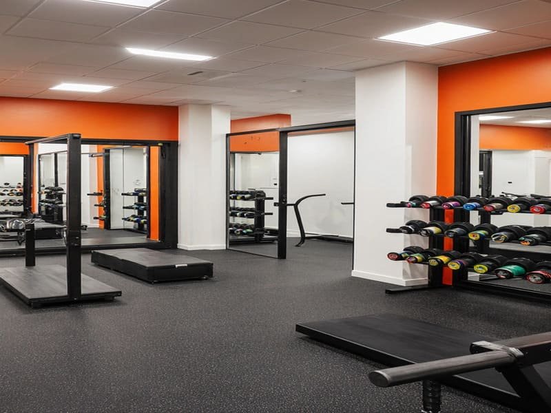 Essential tools for rubber flooring installation laid out on the floor.